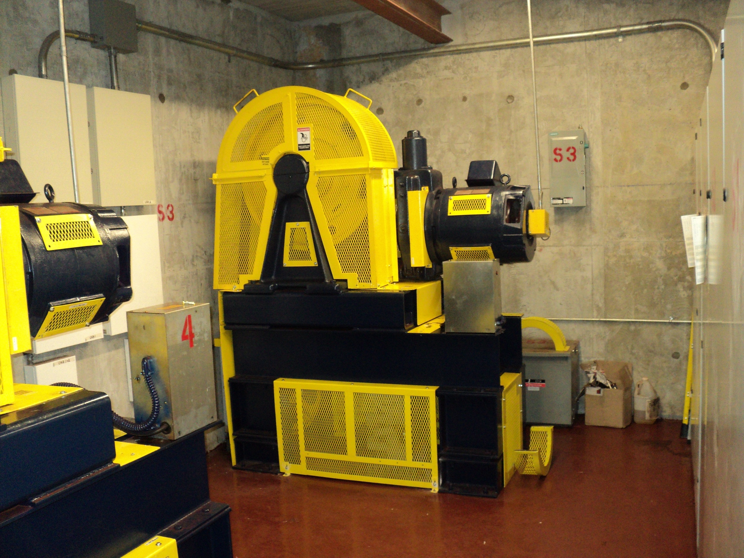 Elevator traction machine with expanded-metal component guards