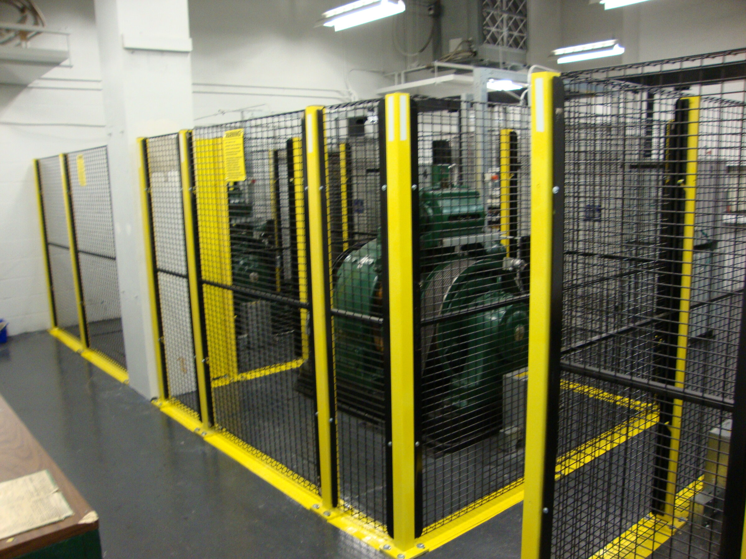 Wire mesh perimeter guarding enclosing elevator machine room equipment