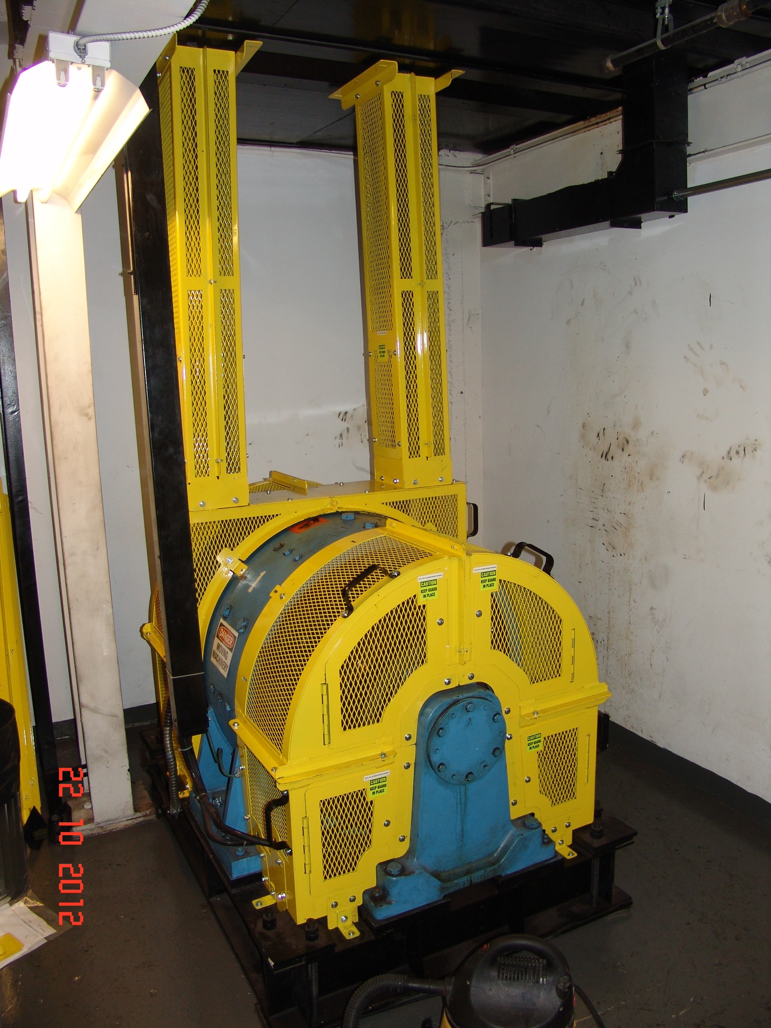 Installed component guard on an elevator traction machine