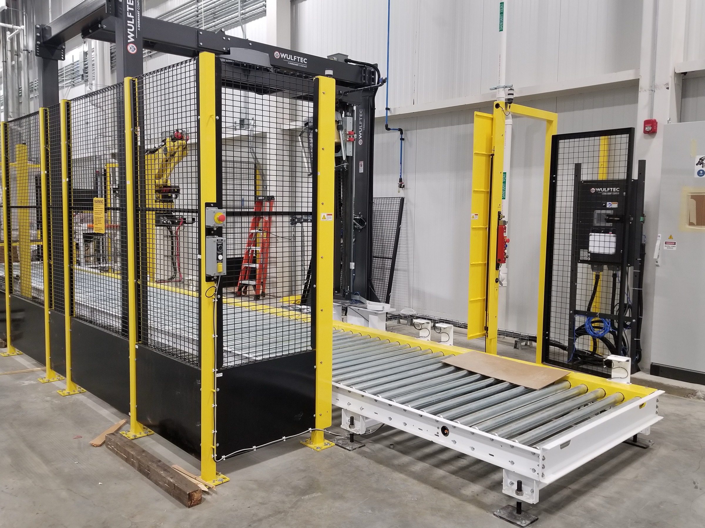 Perimeter guard fence panels and posts along a robotic packaging line