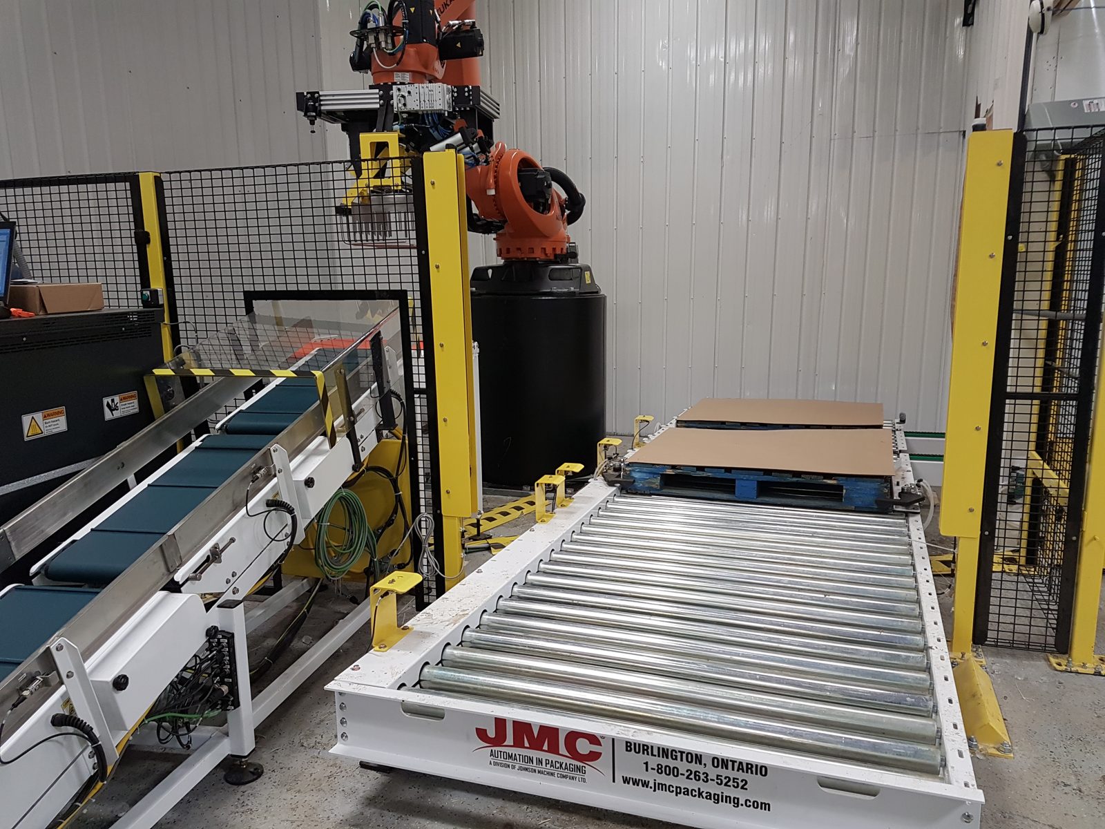 Robotic cell with perimeter guarding and a conveyor access point